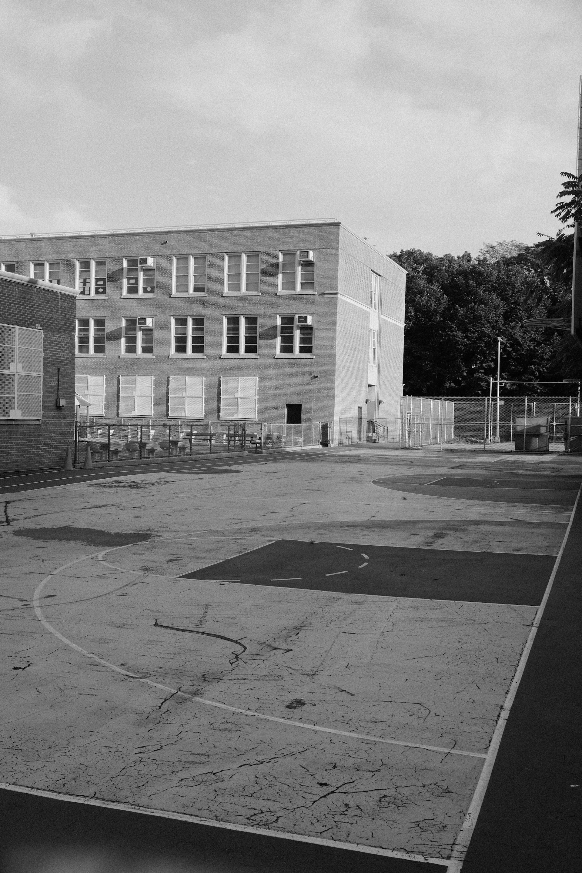 A grey schoolyard with no one there.